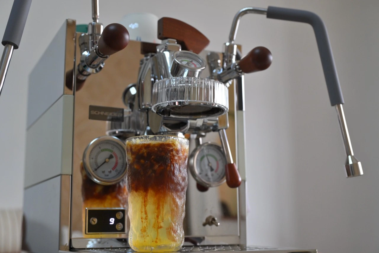An espresso machine and a freshly prepared coffee, original photograph supplied by Liao.